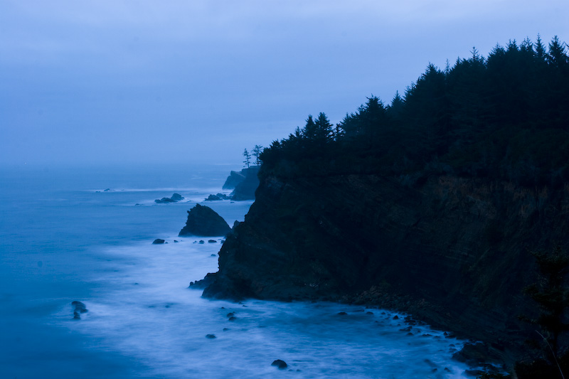 Waves Breaking Against Cliffs At Dawn